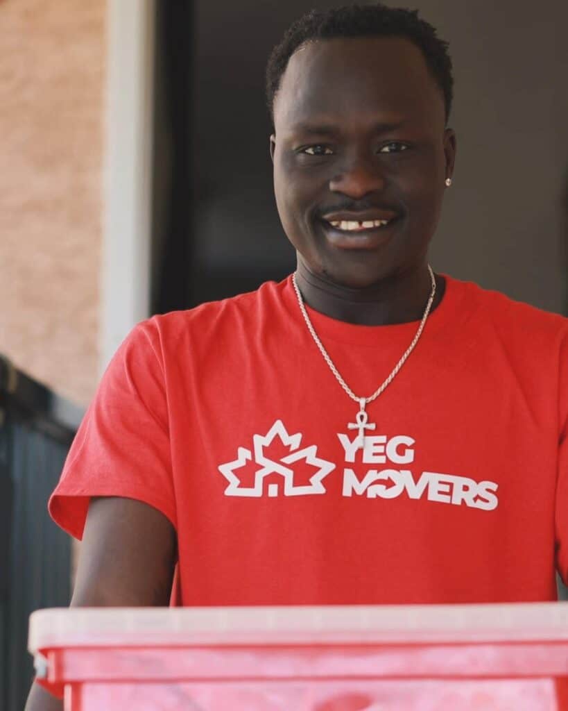 Smiling person in red YEG Movers shirt